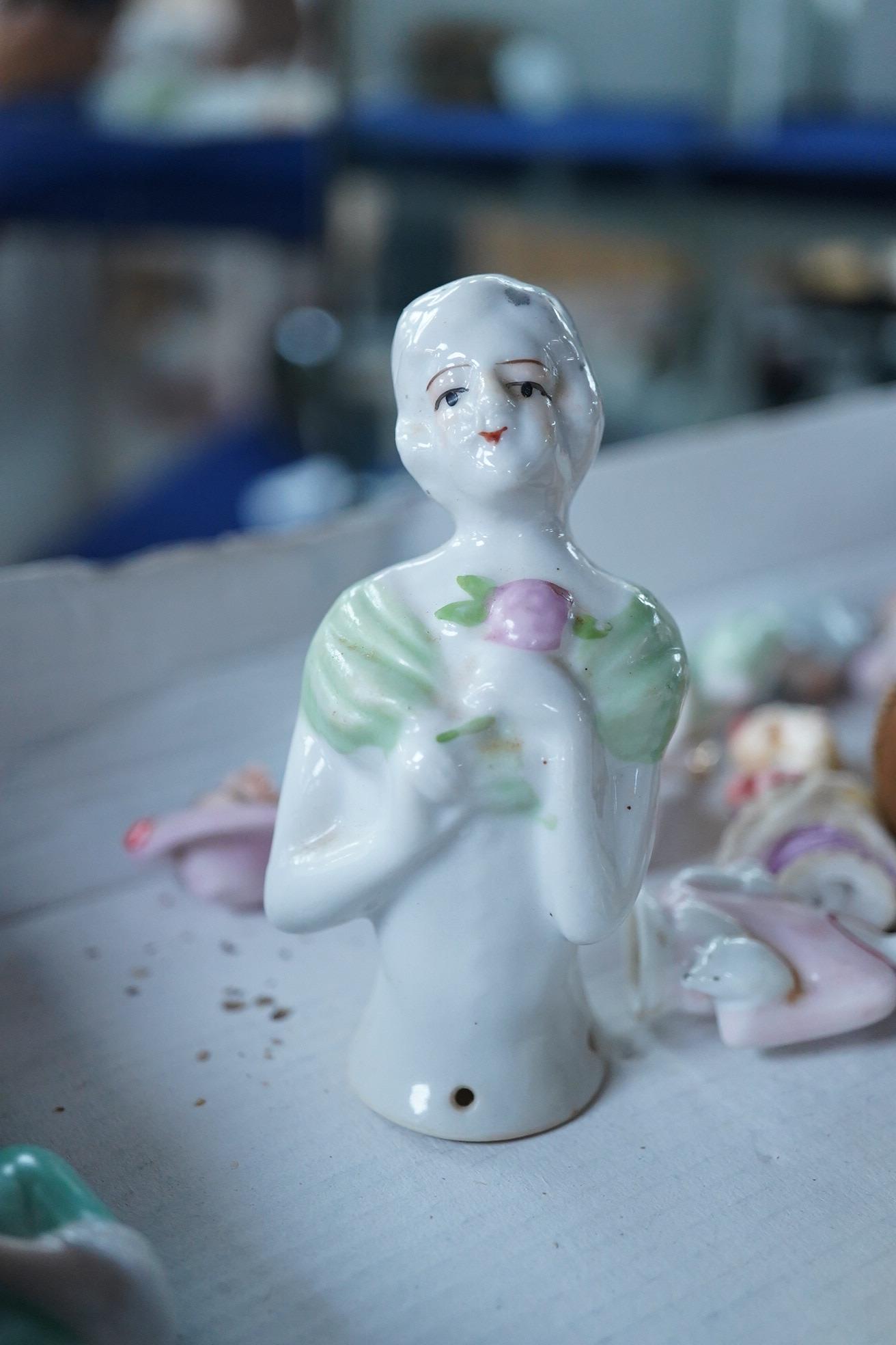A collection of vintage porcelain half dolls and a bisque porcelain example with jointed limbs